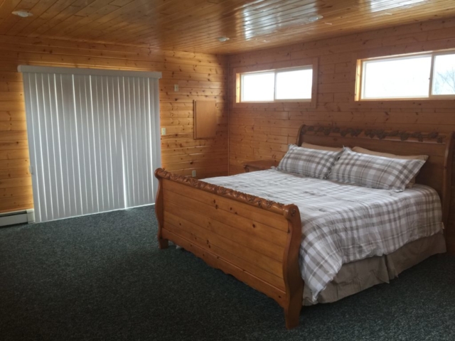 2nd Third floor master bedroom with private deck overlooking front of Torch Lake Lodge.