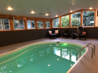 Indoor heated pool and back corner seating at Torch Lake Lodge