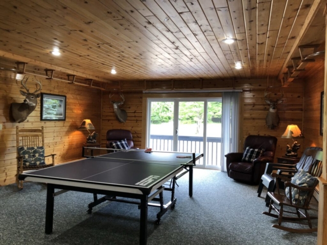 Table tennis and rear 2nd floor deck in the background, facing fire pit and woods